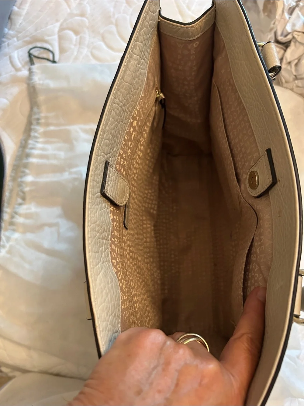 kate spade cream perforated leather tote with black-trim handles